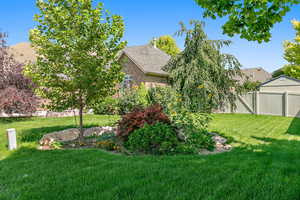 View of yard featuring a gate and fence