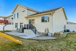 Rear view of house featuring a playground, a patio area, a fenced backyard, and central air condition unit