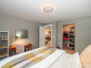 Bedroom featuring carpet flooring and a spacious closet