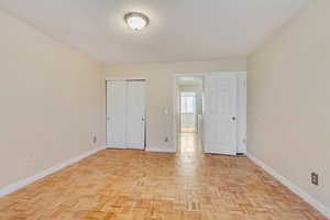 Unfurnished bedroom featuring a closet and baseboards