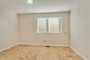 Empty room with visible vents and baseboards