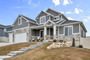 Craftsman-style house with a garage, a front yard, and covered porch