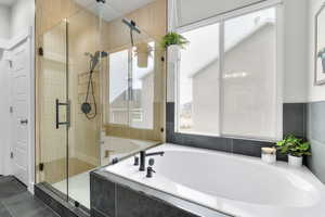 Primary Bathroom featuring shower with separate bathtub