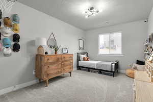 Bedroom with carpet floors and a textured ceiling