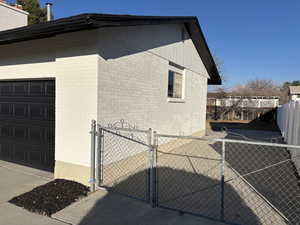 View of property exterior with a gate and fence