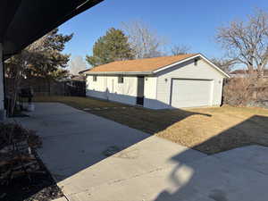 Exterior space featuring fence and a lawn