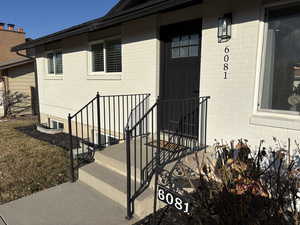 Entrance to property with brick siding