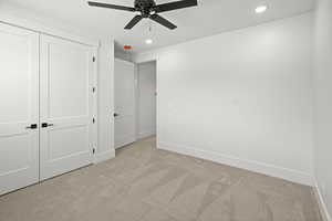 2nd level bedroom featuring light carpet, ceiling fan, a closet, and recessed lighting