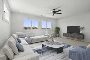 Second level living room with light carpet, a ceiling fan, large windows. Virtually staged.