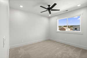 2nd level bedroom with recessed lighting, and light colored carpet
