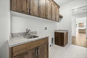 Main floor laundry with granite counter tops and entry to mud room and Primary closet