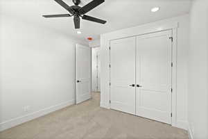 2nd level bedroom featuring light carpet, a ceiling fan, a large closet, and recessed lighting