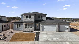 View of front of home featuring roof with shingles, an attached garage, board and batten siding, a residential view, and driveway
