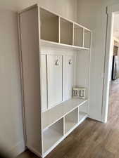 Mudroom featuring wood finished floors and baseboards