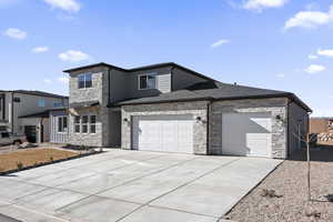 View of front facade featuring a 3-car garage, a shingled roof, concrete driveway, metal roof, and a standing seam roof