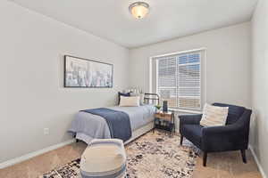 Carpeted bedroom featuring baseboards