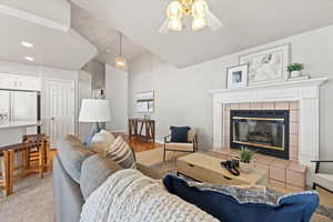 Living area with ceiling fan, recessed lighting, baseboards, vaulted ceiling, and a tiled fireplace