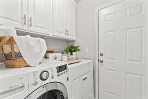 Clothes washing area with cabinet space and washing machine and dryer