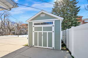 View of shed with a fenced backyard