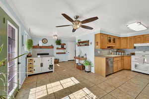 Kitchen featuring under cabinet range hood, light countertops, stainless steel dishwasher, double oven range, and glass insert cabinets