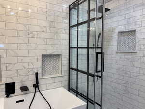 Full bath with a walk in shower and a tub to relax in