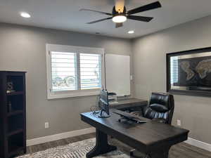 Office with recessed lighting, dark wood-style flooring, ceiling fan, and baseboards