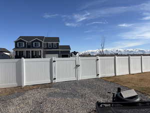 View of yard with fence and a gate