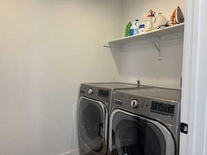 Washroom with laundry area and washer and dryer