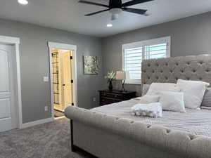 Carpeted bedroom with ensuite bathroom, recessed lighting, a ceiling fan, visible vents, and baseboards