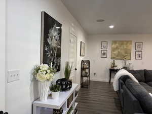 Interior space featuring recessed lighting, dark wood-style flooring, and baseboards