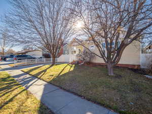 View of front of property featuring a front lawn and fence