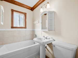 Bathroom with toilet and a garden tub