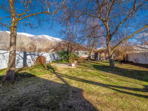 View of yard with fence private yard and a mountain view