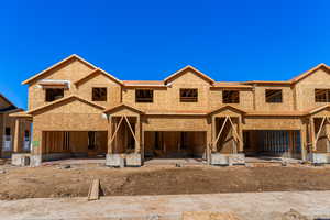 Unfinished property featuring an attached garage