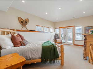 Bedroom with light colored carpet, recessed lighting, visible vents, access to outside, and french doors