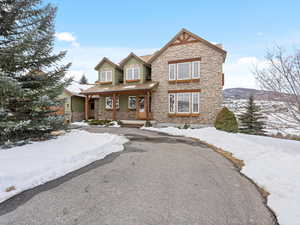 Craftsman-style home with a porch and stone siding