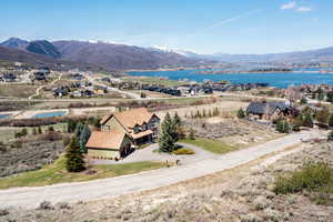 Birds eye view of property with a water and mountain view