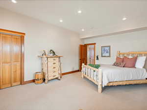 Bedroom featuring recessed lighting, light colored carpet, and baseboards