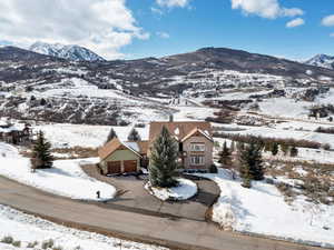 Snowy aerial view featuring a mountain view