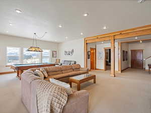 Living room with recessed lighting, pool table, light carpet, a textured ceiling, and baseboards