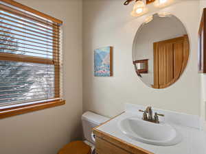 Half bathroom featuring toilet and vanity