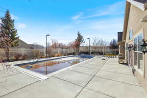 View of pool with a fenced in pool, a patio area, and a fenced backyard