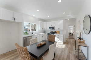 Dining room with recessed lighting and light wood-style floors