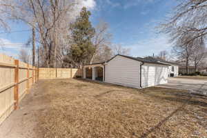 Exterior space featuring a garage and a fenced backyard