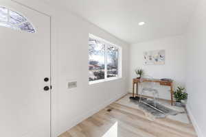 Interior space with light wood-style flooring, visible vents, baseboards, and a wealth of natural light