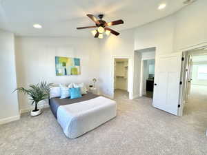 Carpeted bedroom featuring a spacious closet, baseboards, and recessed lighting