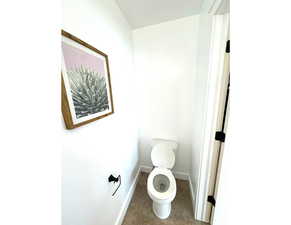 Bathroom featuring toilet and baseboards