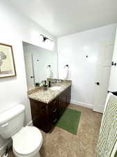 Bathroom with baseboards, vanity, and toilet