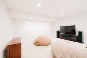 Bedroom with recessed lighting and light colored carpet