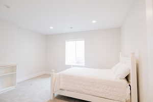 Bedroom featuring recessed lighting, and light colored carpet